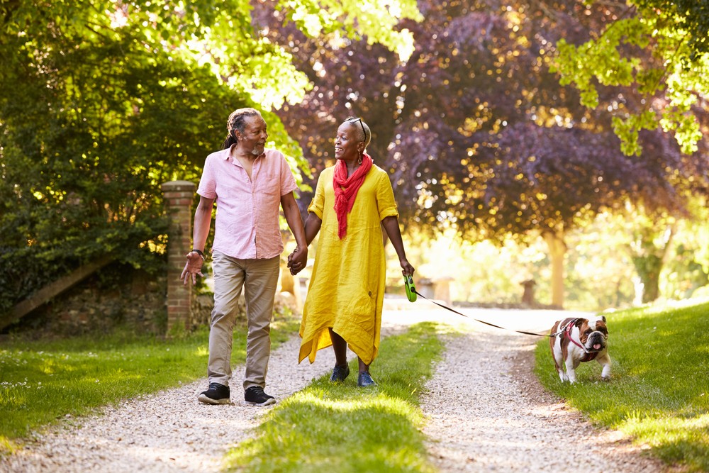 Senior couple taking dog for a walk