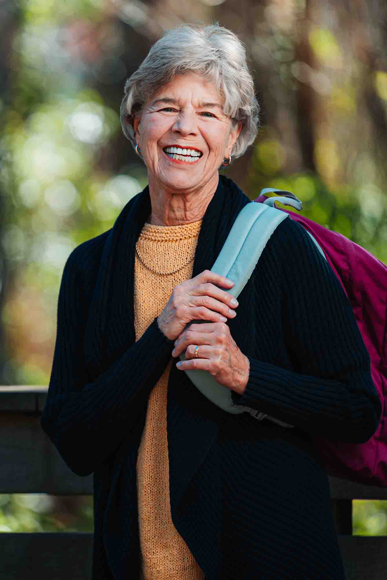 Senior woman with a backpack over her shoulder