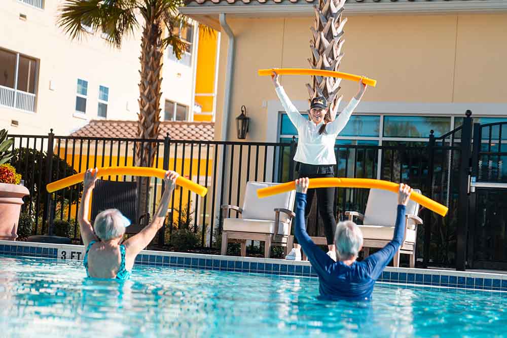 A senior water aerobics class in an outdoor pool