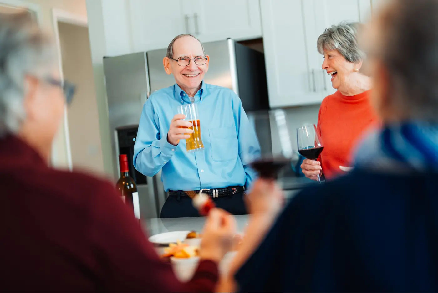 Senior man enjoying food and drinks with friends